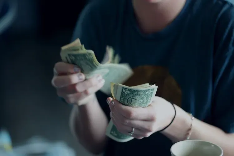 A person sorting through cash.