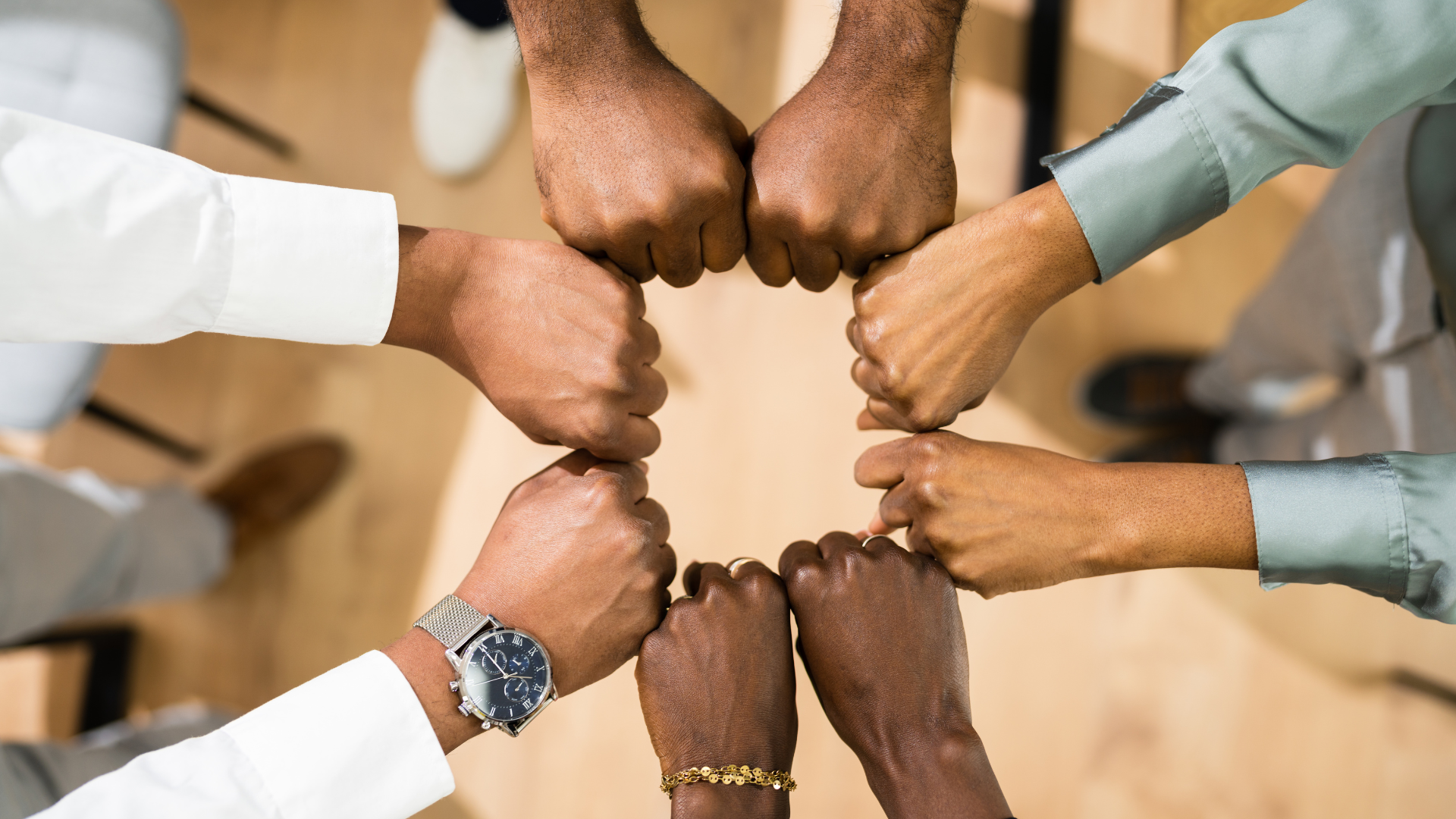 4 sets of hands making a circle