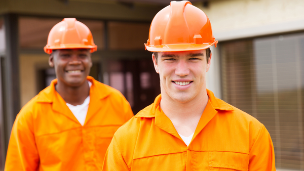 Two restoration workers wearing orange PPE