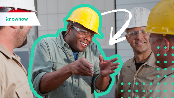 construction workers with hard hats huddled in a circle talking